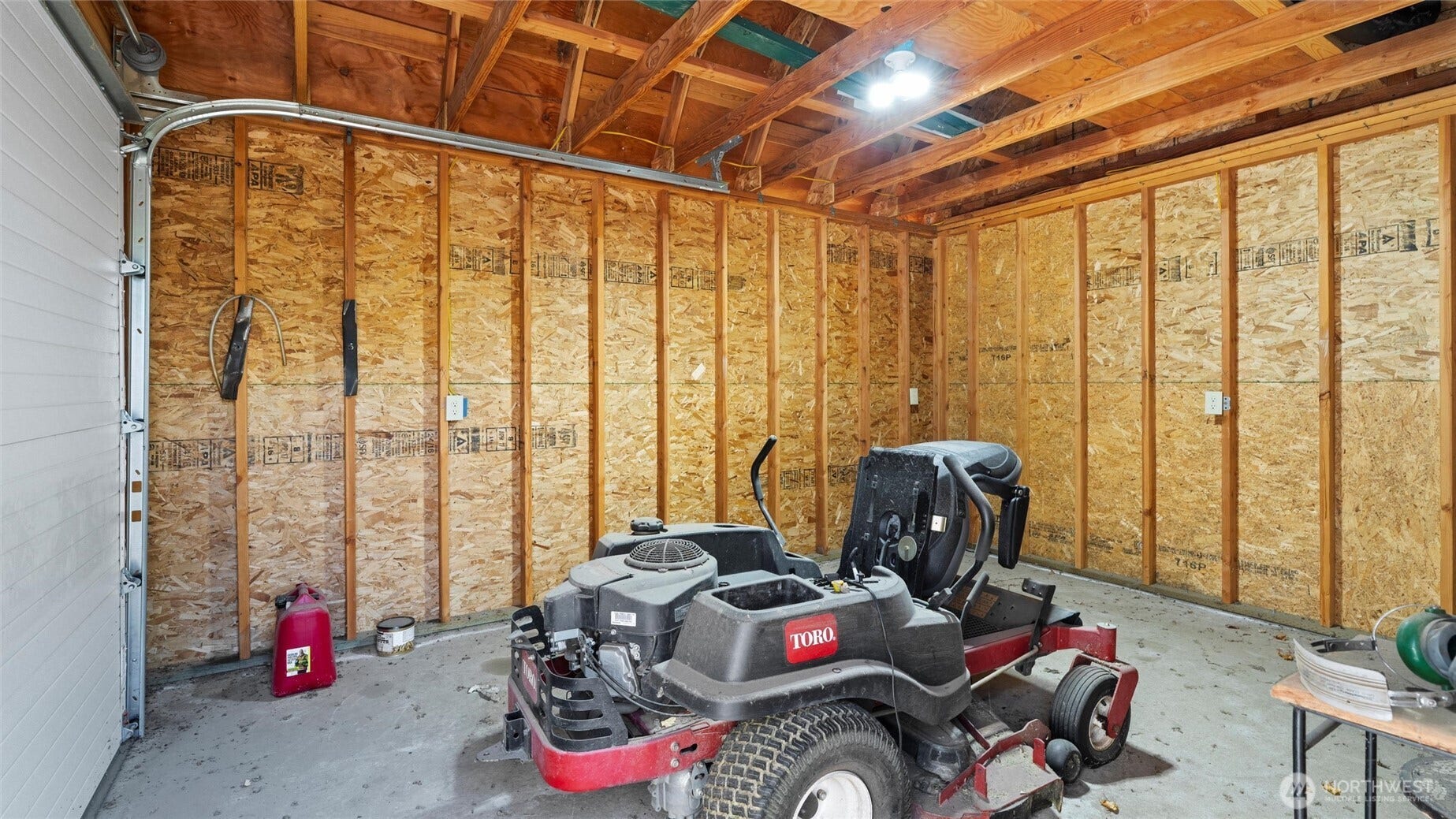 Garden shed with roll-up door.