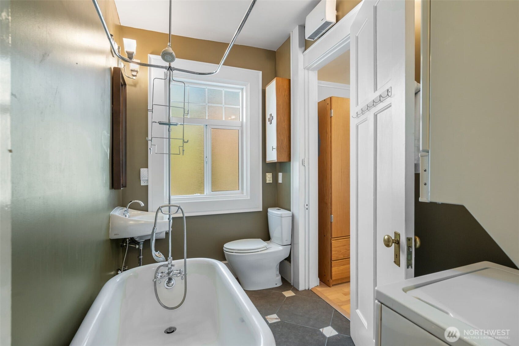 403 Terry Avenue, #206, Seattle, WA 98104 Bathroom newly remodeled, featuring claw foot tub, in-unit W/D.