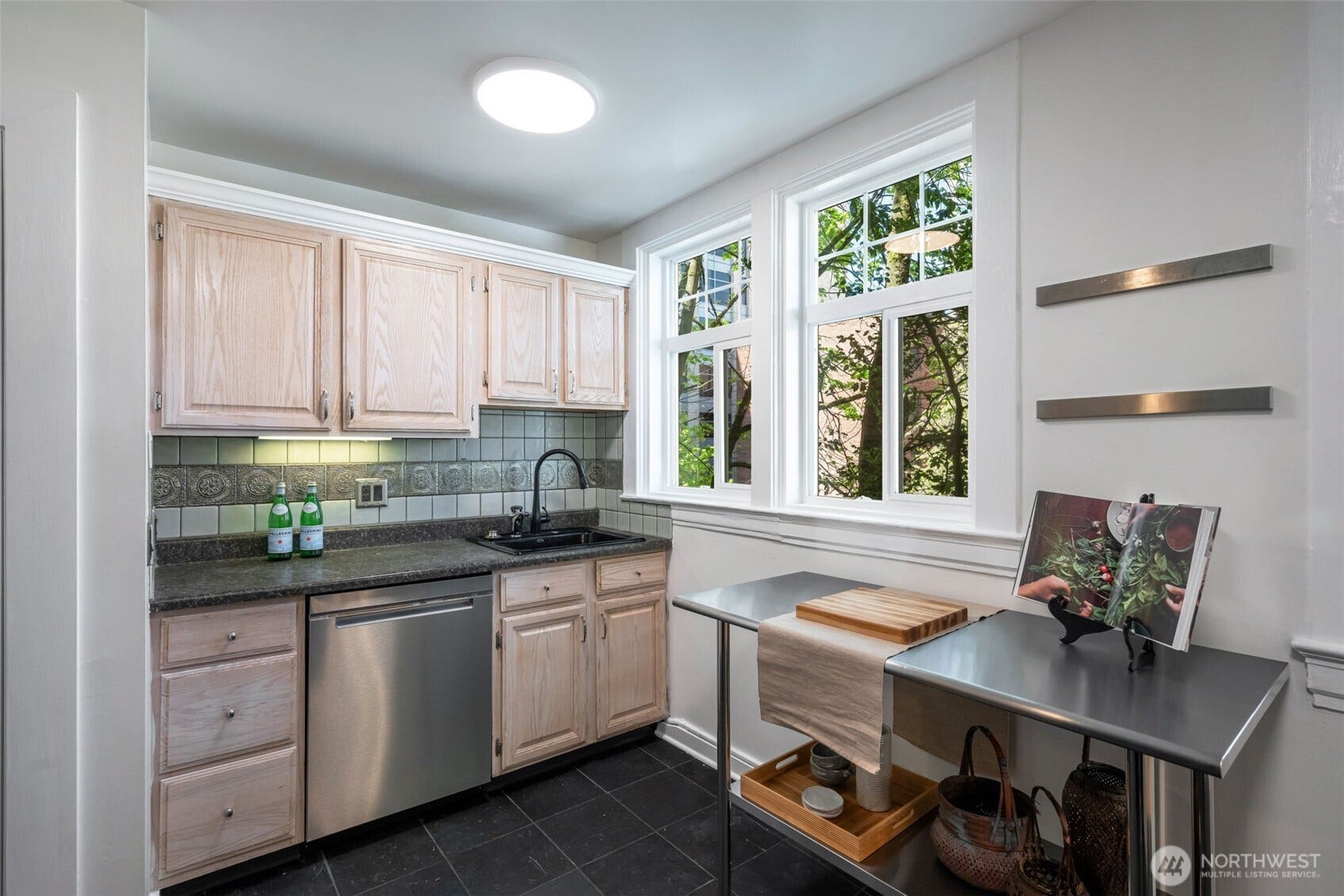 403 Terry Avenue, #206, Seattle, WA 98104 Bright kitchen with slate tile and glass doored pantry.