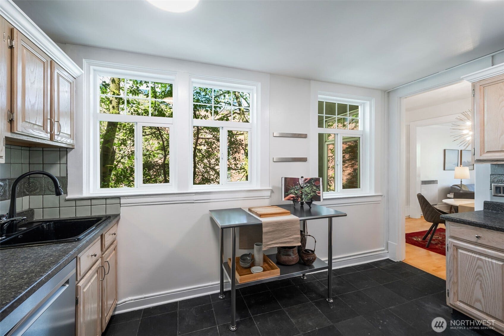 403 Terry Avenue, #206, Seattle, WA 98104 Light and bright kitchen with slate tile and glass doored pantry. Metal utility table can convey.