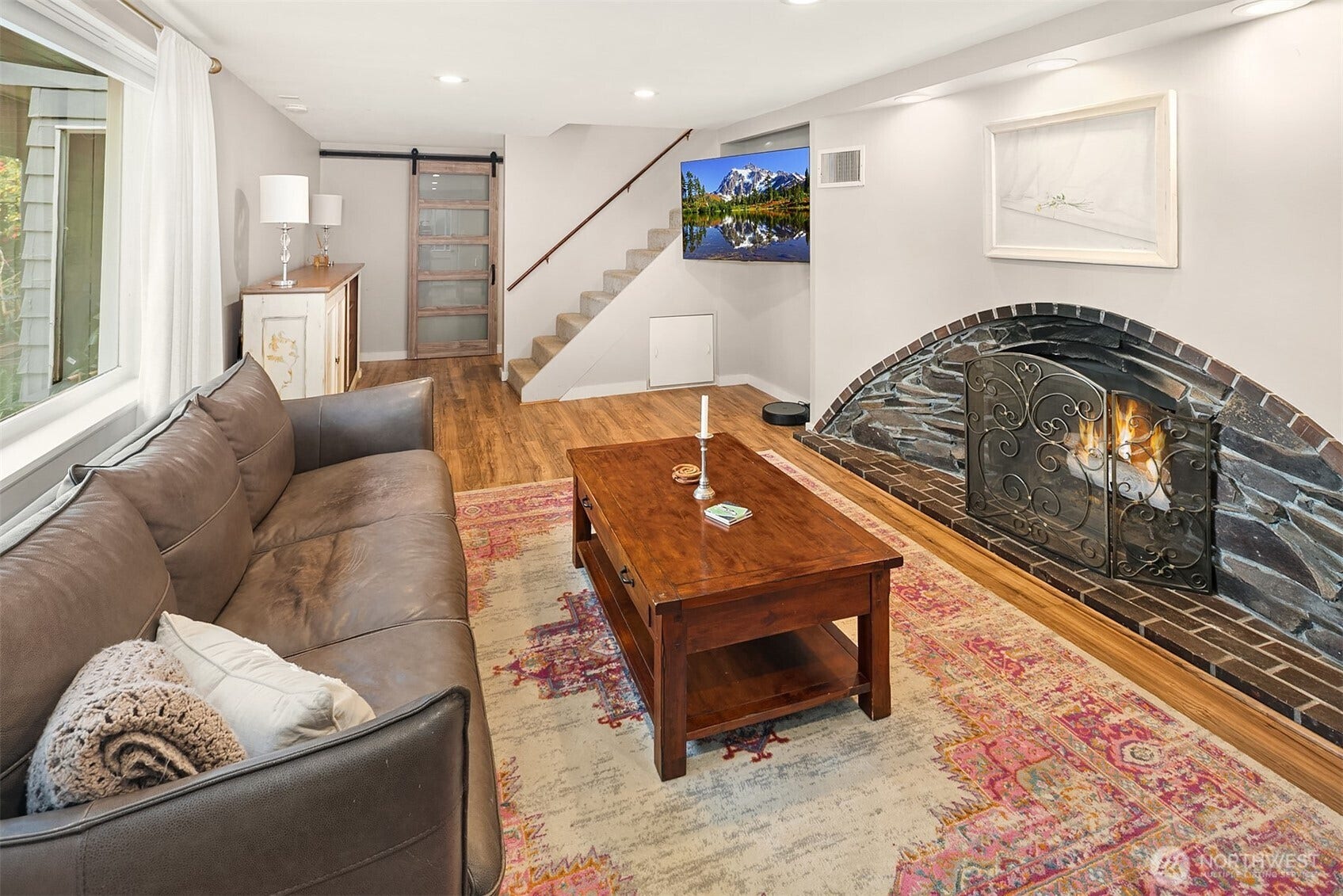 The lower level living area is graced with this gorgeous arched cove-style fireplace with gas insert.