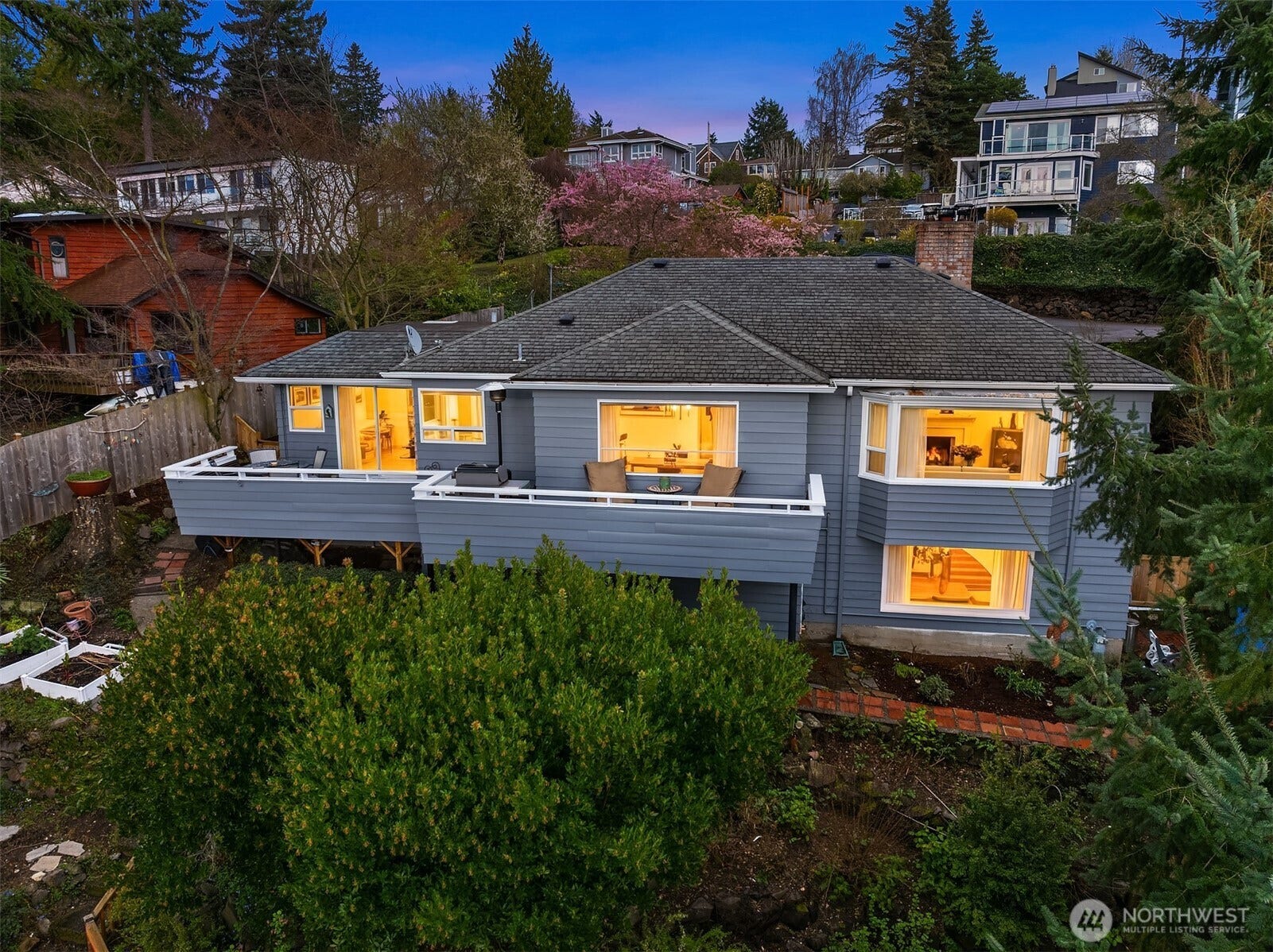 Nestled into the hillside, this Three Tree Point home is an aerial refuge among the trees.