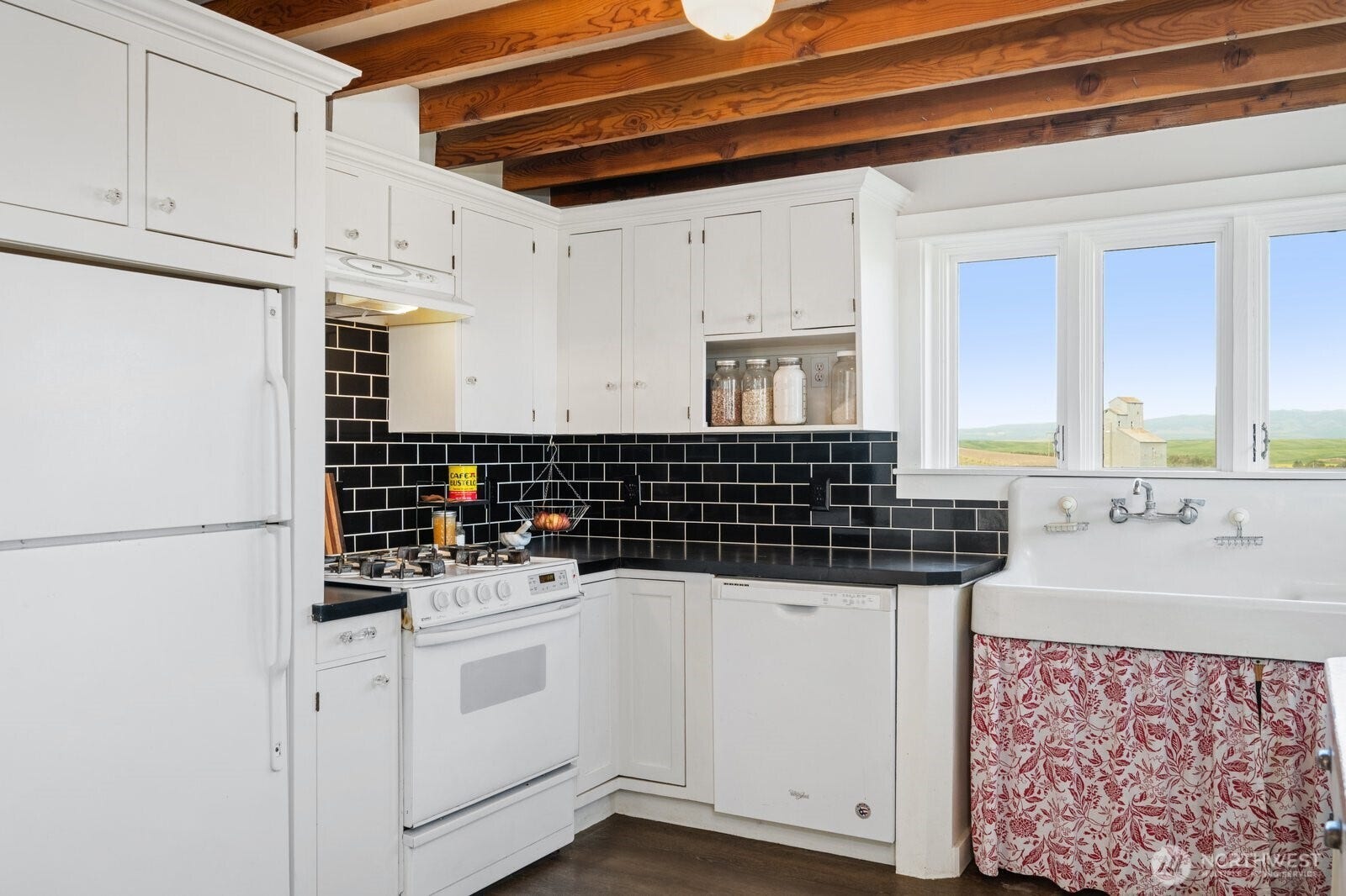 Kitchen updates include newer cabinets, dishwasher & gas range