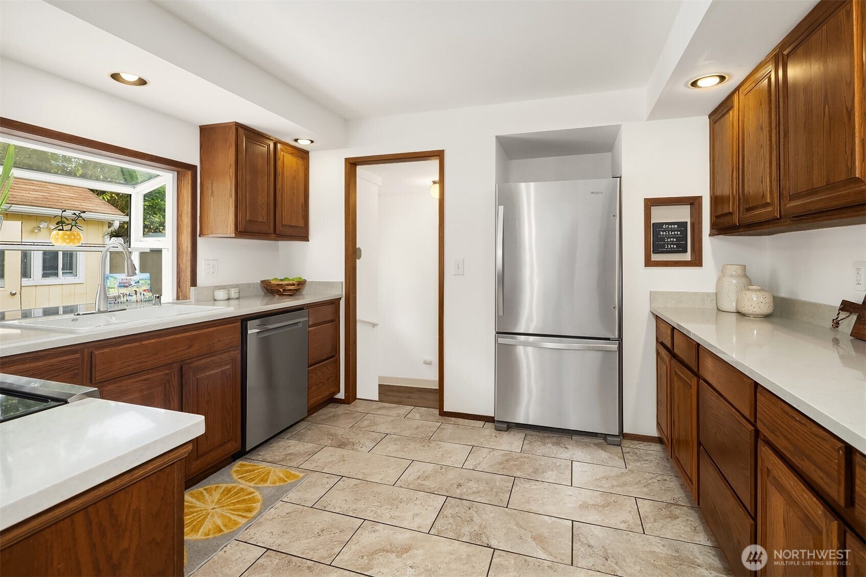 11510 27th Avenue SW, Burien, WA 98146 Nice sized kitchen with gleaming cabinets, garden window and stainless appliances.