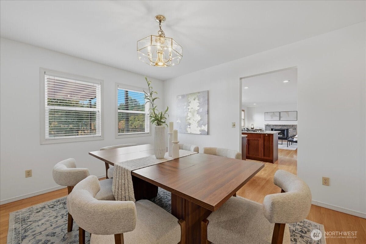 13408 SE 85th Street, Newcastle, WA 98059 Dining room with real hardwood floors can easily accommodate a 6 person table with room to spare. Dining room adjoins the living room and the kitchen with great room concept providing the perfect flow for entertaining and gatherings.