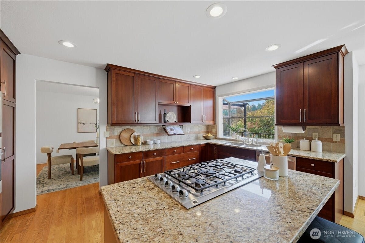 13408 SE 85th Street, Newcastle, WA 98059 Beautifully remodeled kitchen is in excellent condition just like the rest of the home. Hardwood floors, Stainless Appliances, Gas Cooktop and Slab granite counters round out this well designed kitchen with cherry cabinetry.