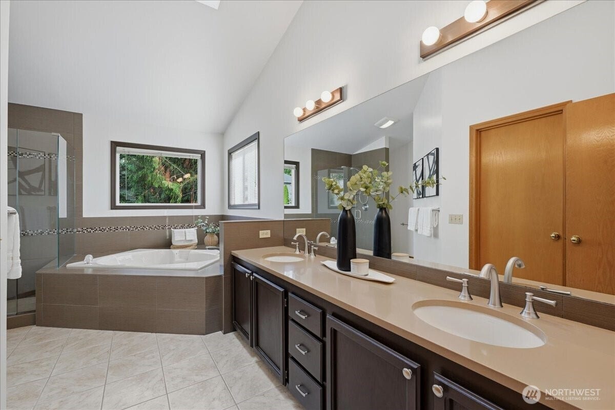 13408 SE 85th Street, Newcastle, WA 98059 Primary bath with vaulted ceilings, dual vanities, soaking tub and shower with frameless door.