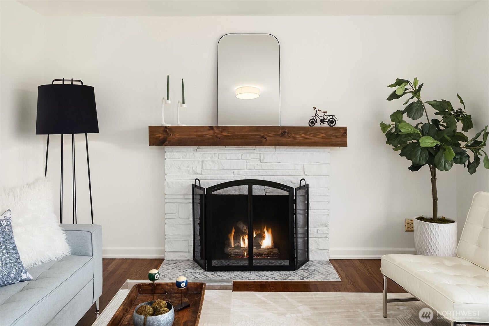 A cozy fireplace is the focal point of this light-filled living room.