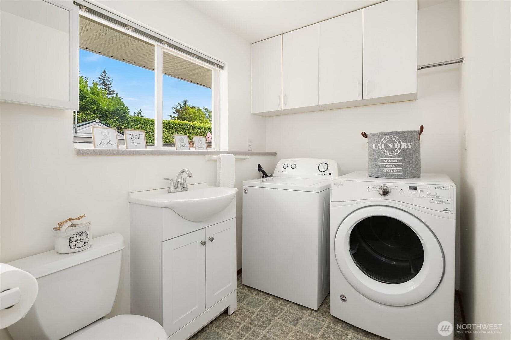 Laundry room and half bath off the kitchen and bonus room.