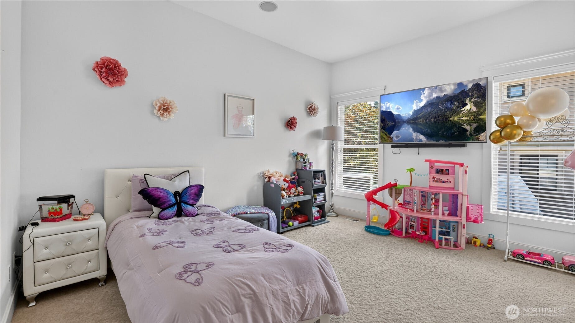 This spacious bedroom offers a bright and inviting atmosphere with large windows that fill the space with natural light. Neutral walls and plush carpeting create a calm, comfortable setting, while the clean lines and modern finishes reflect the homes refined design. The layout provides ample room for furniture and play, making it versatile for any age or purpose. Elegant trim work and high ceilings enhance the sense of openness, maintaining the sophisticated style found throughout the estate.