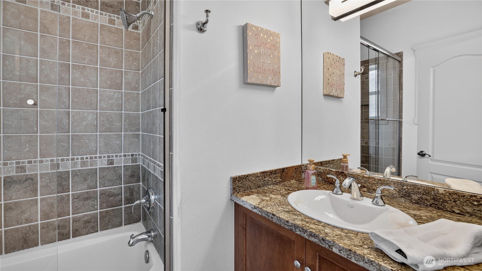Full Bathroom    This well-appointed full bath features a granite countertop vanity, tile-surround tub and shower, and polished chrome fixtures for a clean, timeless look. Neutral tones and quality finishes create a warm, inviting atmosphere, perfectly balancing style and functionality for everyday use or guest comfort.