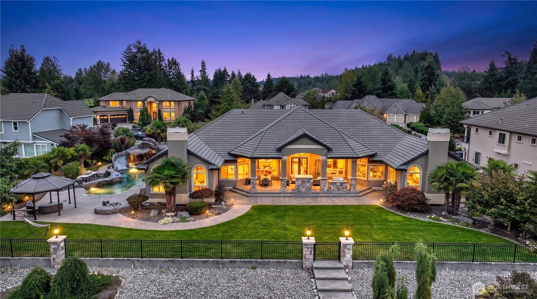 tep into your own private retreat in this stunning estate where elegance meets recreation. The homes rear elevation reveals a seamless blend of indoor-outdoor living  a spacious kitchen opens to the backyard oasis, perfect for entertaining or relaxing after a round of golf. Expansive tile flooring, bright natural light, and clean lines create a sense of openness and comfort. The backyard unfolds to serene lake views, offering a tranquil backdrop for gatherings and everyday living. Whether enjoying the pool, hosting dinner under the covered patio, or simply taking in the peaceful surroundings, this residence embodies the best of resort-style living in one of Auburns most coveted golf communities.