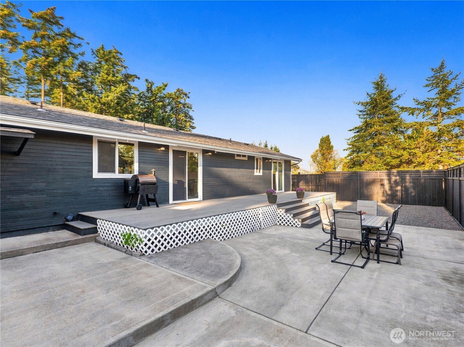 1409 1st Street, Port Townsend, WA 98368 Sliding glass door and kitchen window connect the back deck to the kitchen and dining area - perfect for easy indoor-outdoor entertaining and gatherings.
