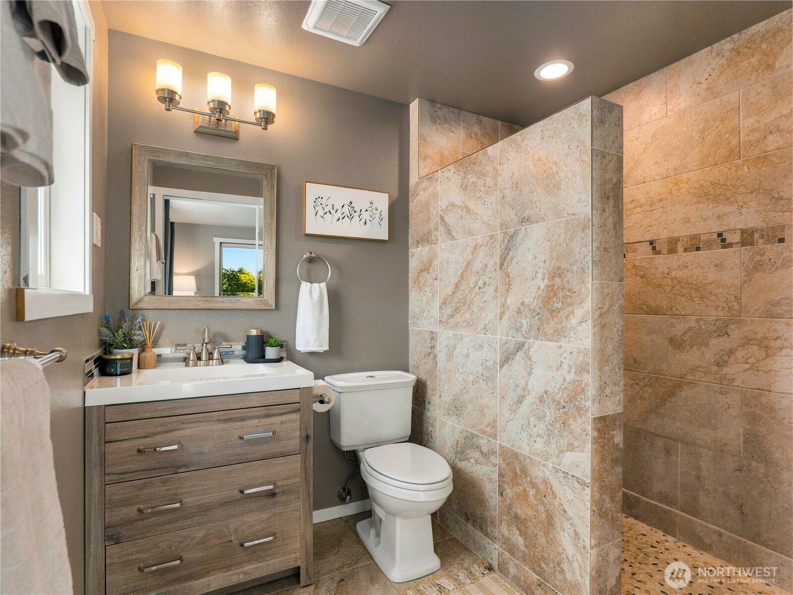 1409 1st Street, Port Townsend, WA 98368 Updated primary bathroom featuring a custom tile surround, new vanity, flooring, and fixtures.