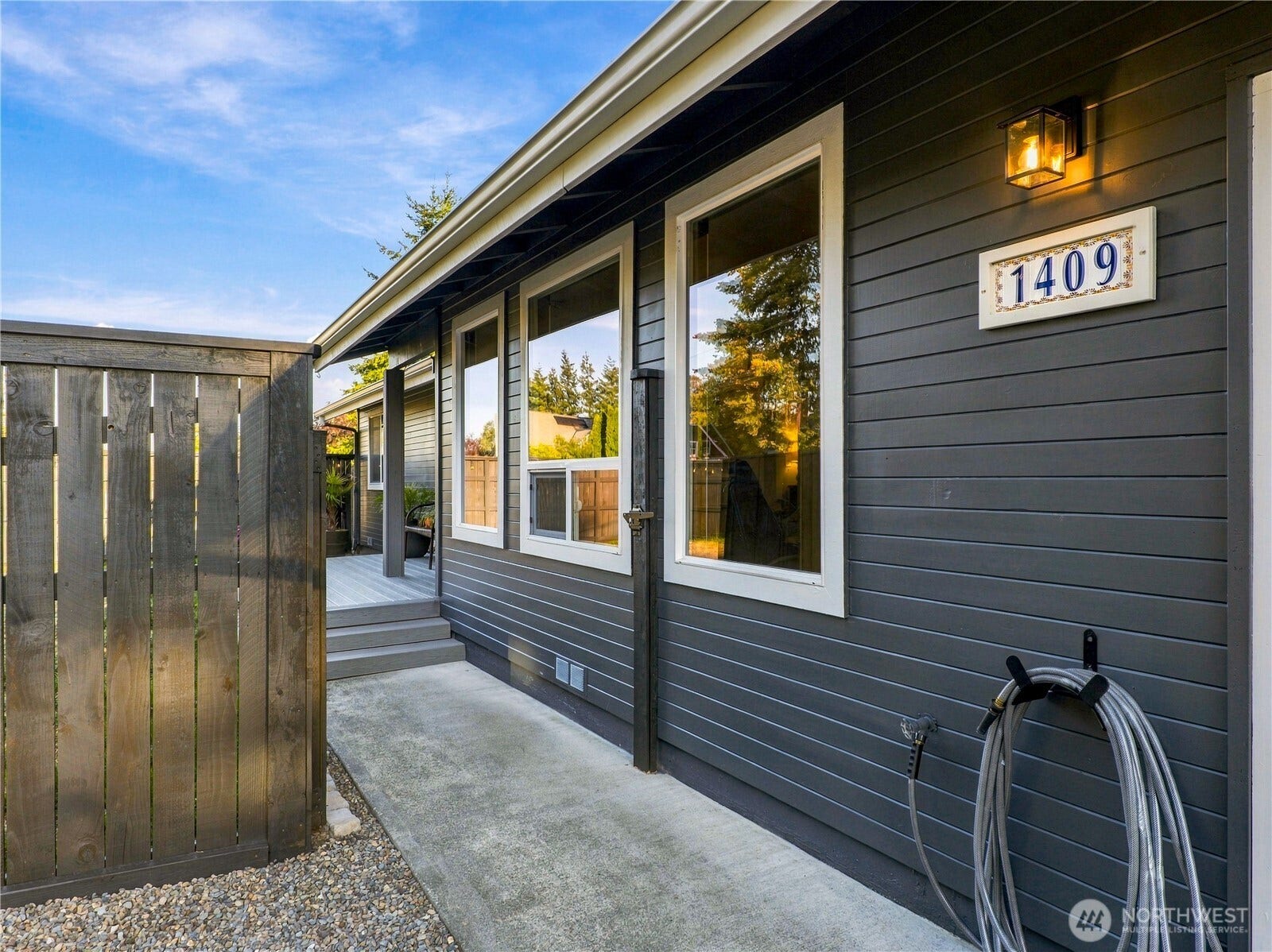 1409 1st Street, Port Townsend, WA 98368 Gated entry leads to the front door and deck, with a fully fenced front yard for added privacy and outdoor enjoyment.