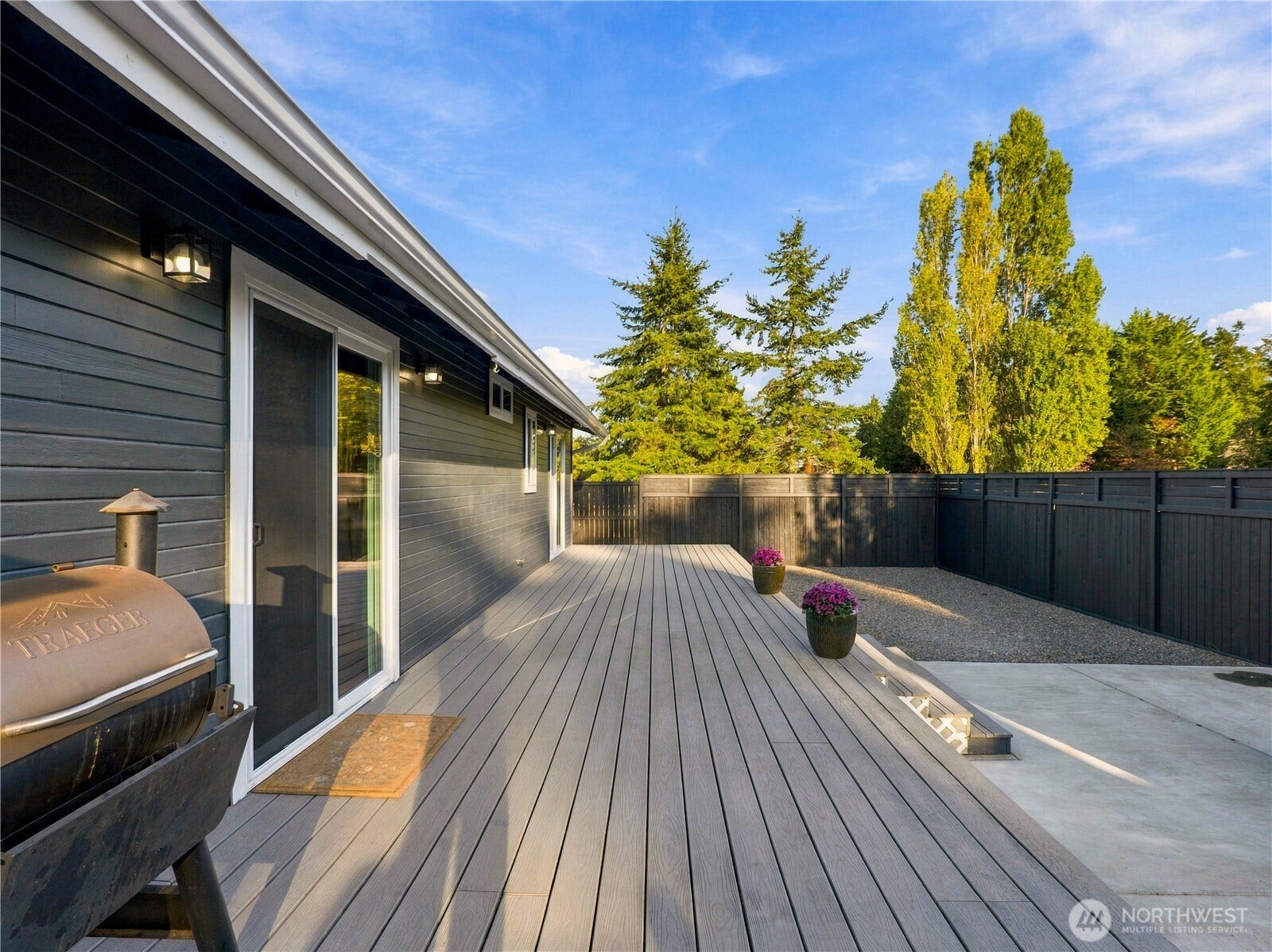 1409 1st Street, Port Townsend, WA 98368 Fully fenced backyard with a new Trex deck and freshly painted fencing, plus a poured concrete pad with 240V electrical already in place for a future hot tub.