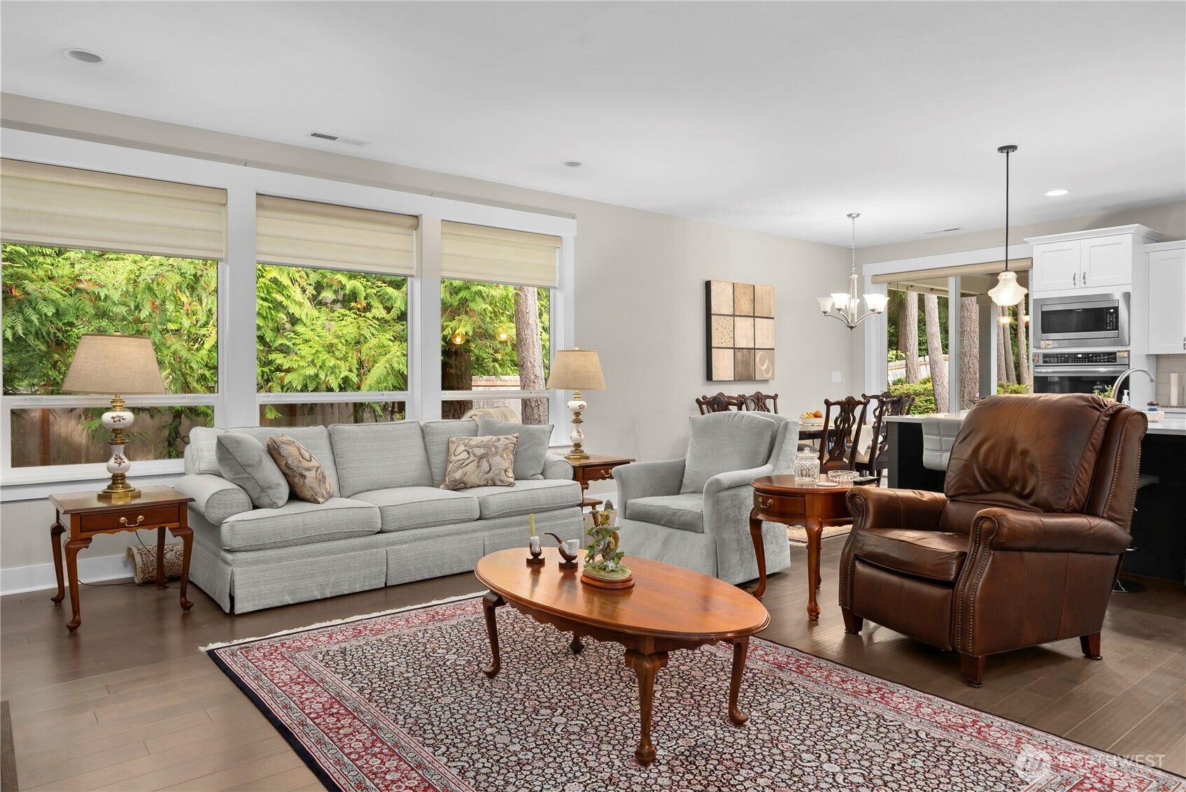 3413 Fox Court, Gig Harbor, WA 98335 The entry hall opens to the seamless flow of the living, dining, and kitchen areas. Great room design and huge windows let natural light and greenery in.