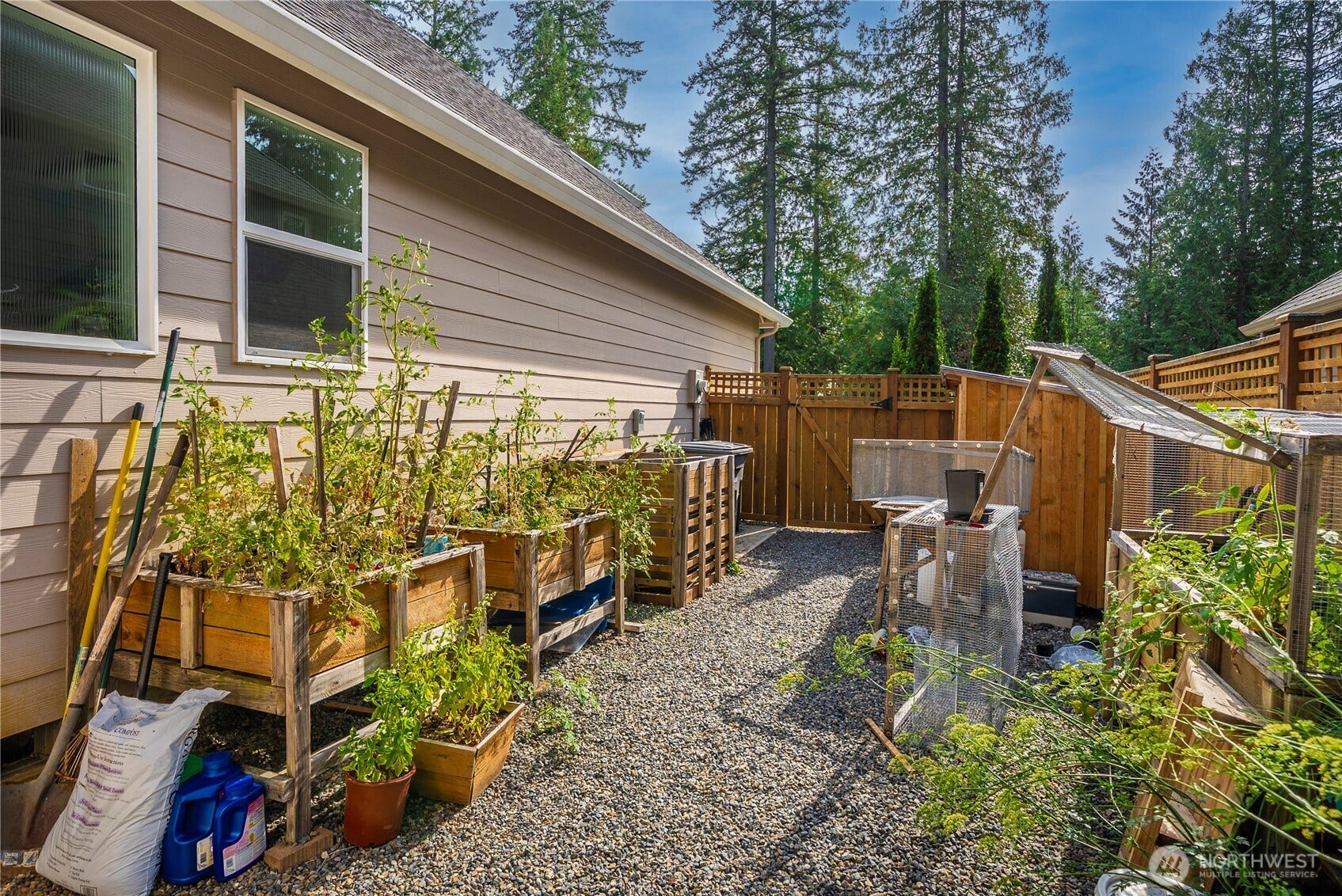 3413 Fox Court, Gig Harbor, WA 98335 The fully fenced area on the left side of the home is complete with planters and a gardening shed - all ready for your green thumb.