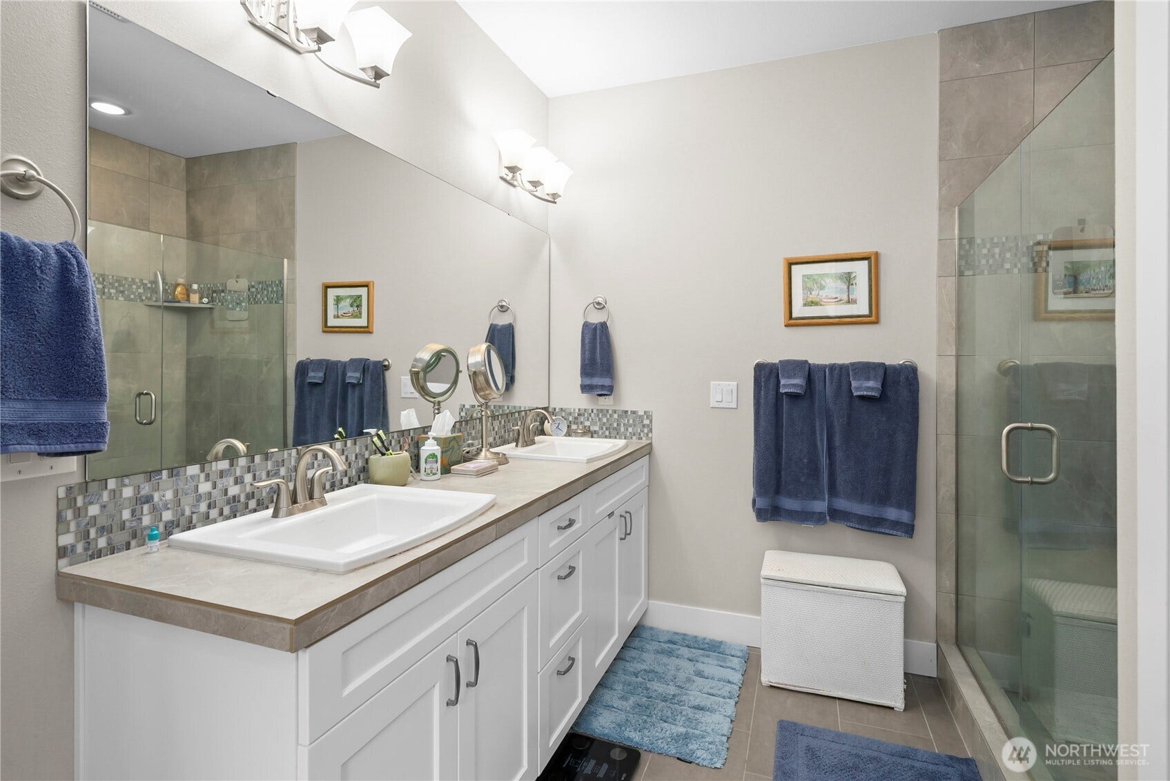 3413 Fox Court, Gig Harbor, WA 98335 Primary bath complete with double sinks, tiled shower, and a soaking tub.