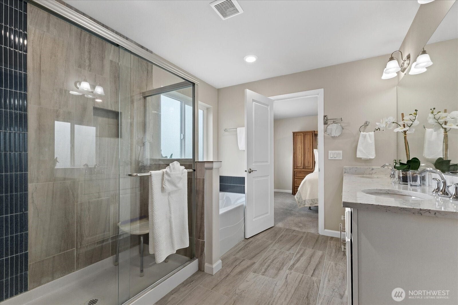 10419 11th Street Ct E, Edgewood, WA 98372 A beautiful spa like Primary Bath features a huge walk-in Tiled Shower and Soaking Tub.