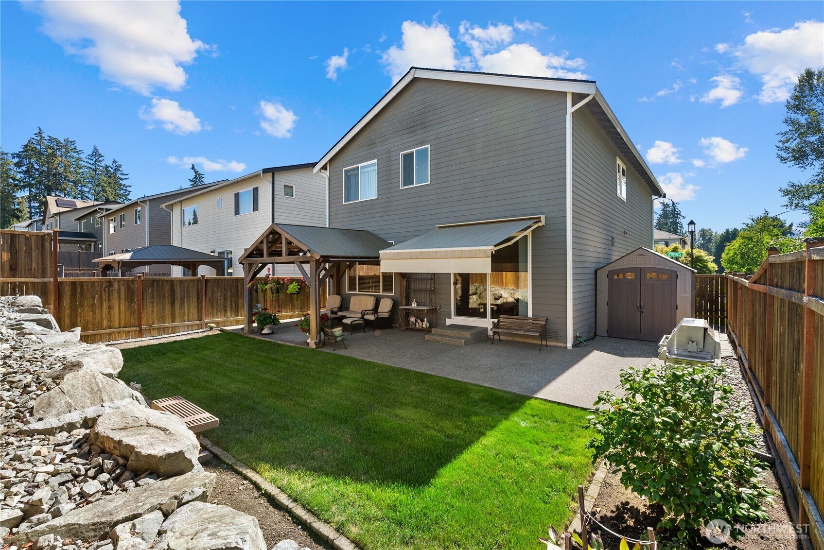 10419 11th Street Ct E, Edgewood, WA 98372 Cement garden curbs and concrete sidewalks on both the garage side yard and the shed side yard. Plus and Expanded Patio for more room to relax!
