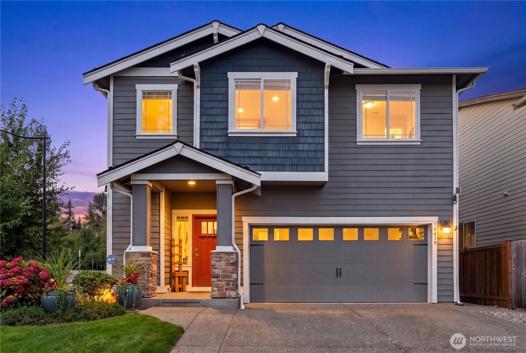 10419 11th Street Ct E, Edgewood, WA 98372 This previous builder Model Home is enhanced with a handsome Brick accented columned front porch that welcomes guests.