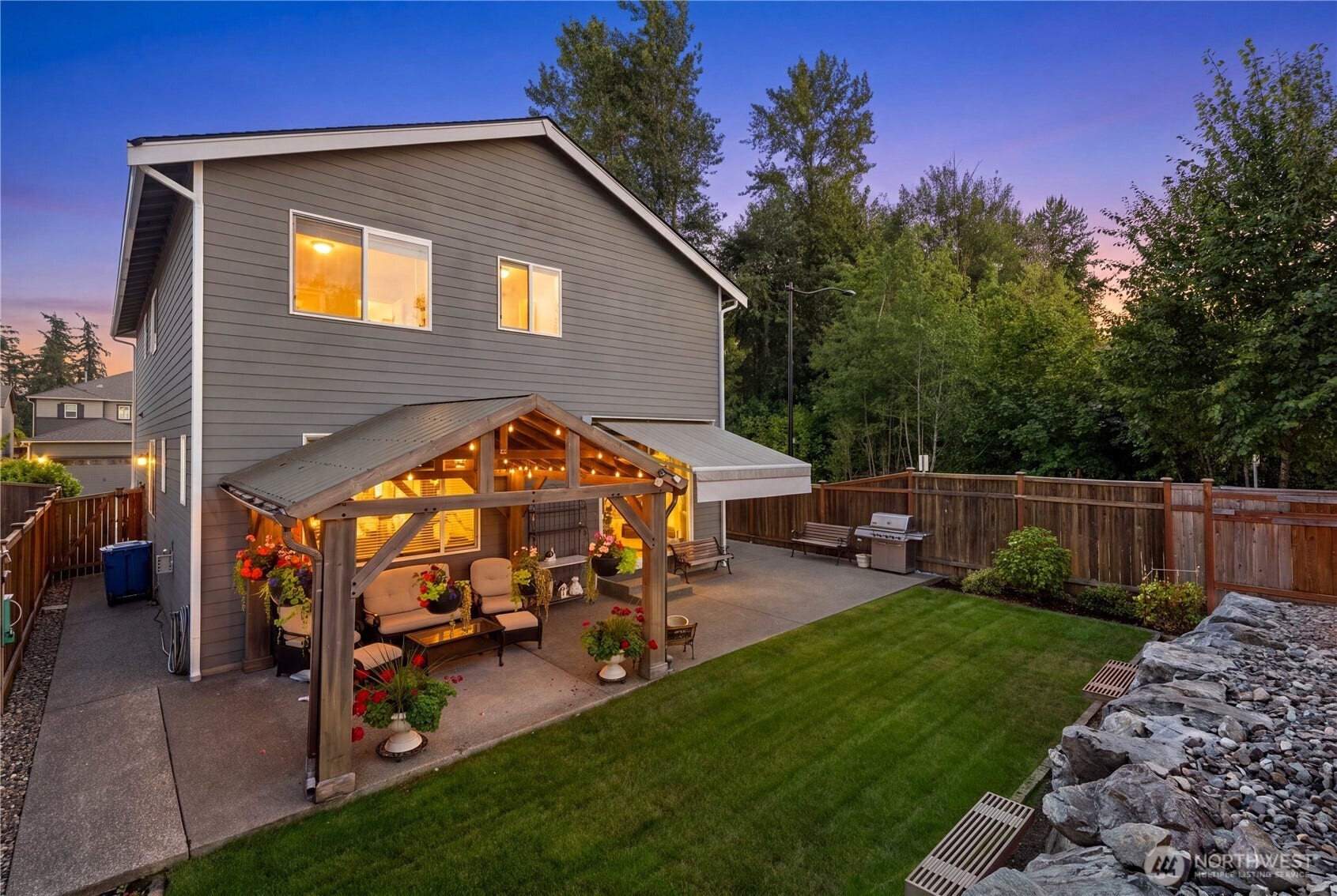 10419 11th Street Ct E, Edgewood, WA 98372 Enjoy the large expanded Patio areas with a Covered structure and an additional awning over the entry doors to the rear yard.