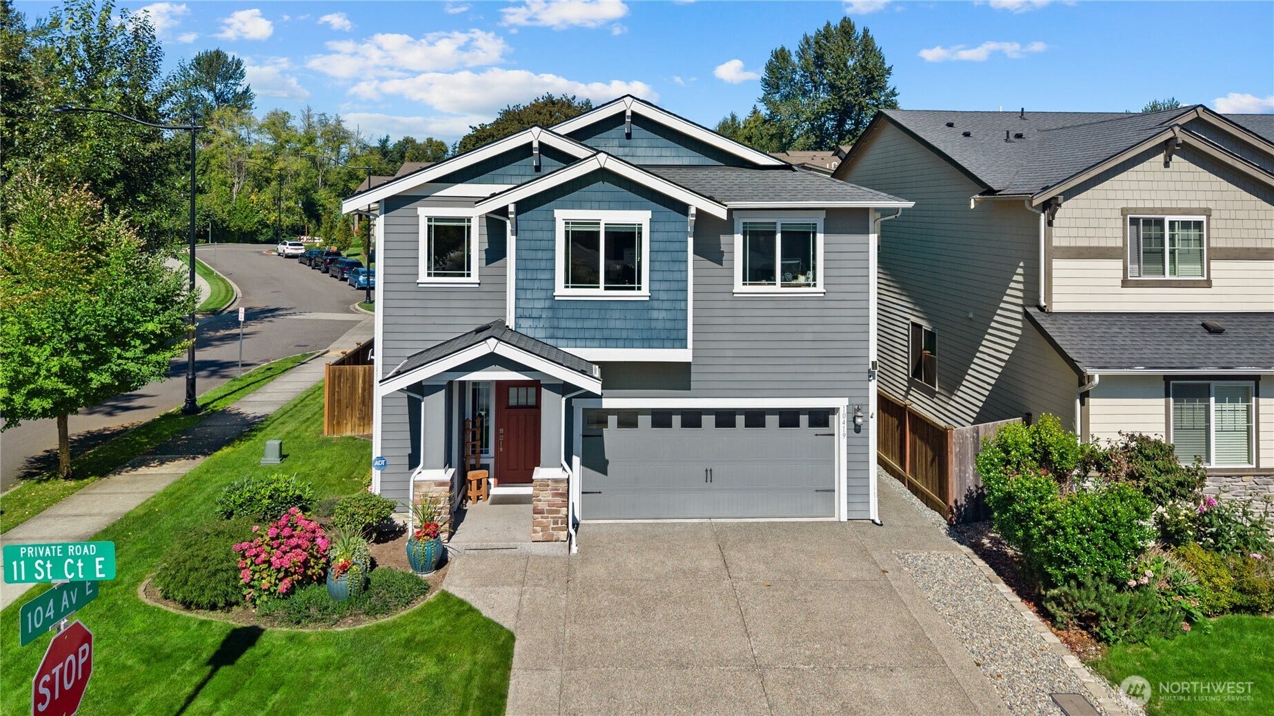 10419 11th Street Ct E, Edgewood, WA 98372 A lush green area is adjacent to this home for added beauty.