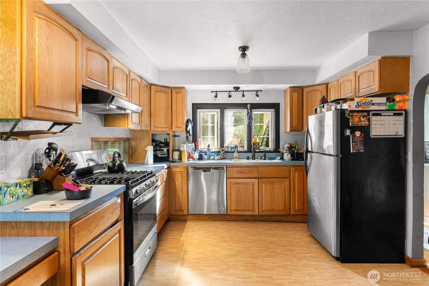 Kitchen with propane range- all appliances stay