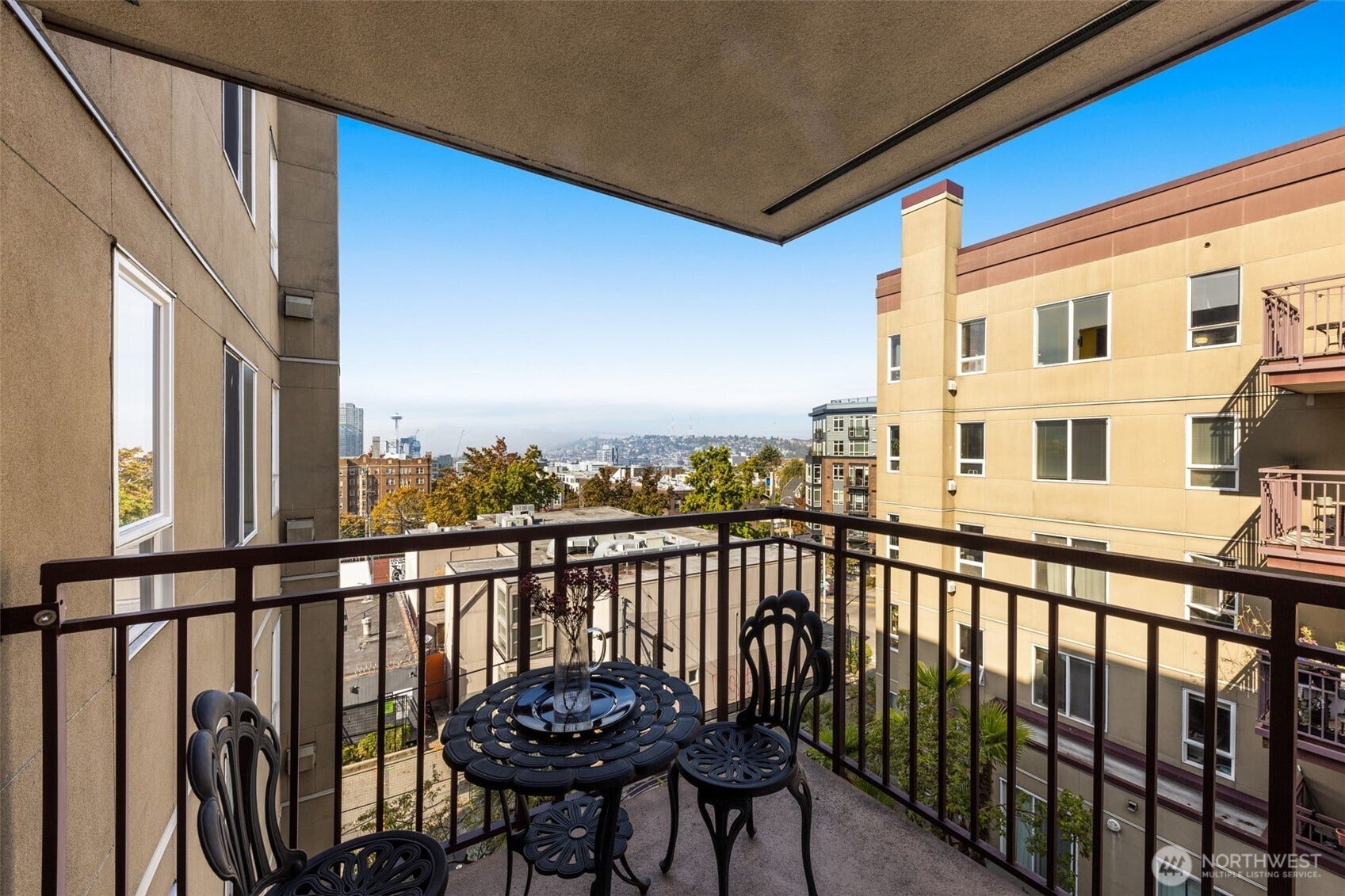 Private balcony overlooking a combination of the city and Capitol Hill's greenery