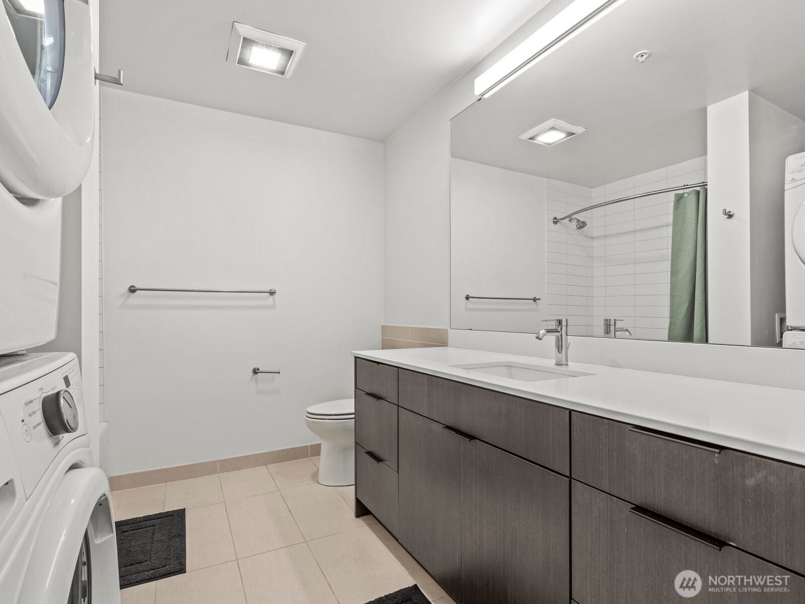 Immediately on the left is the generously sized bathroom where you'll find the full sized washer and dryer as well.