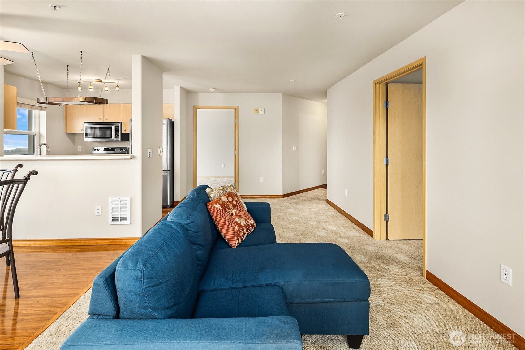 Spacious living area with adjacent bedroonms.