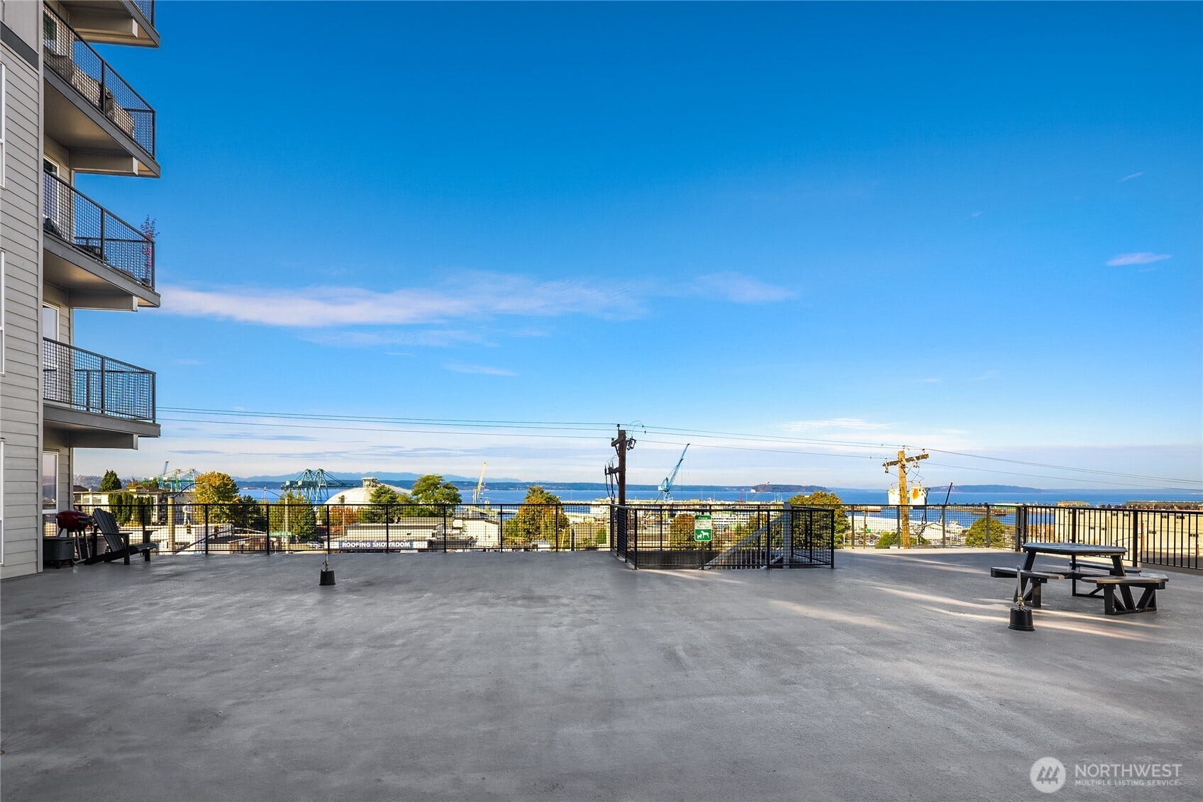 Community amenities include secure garage parking, storage, fitness center, landscaped courtyard and rooftop deck with panoramic views. Nautica Soundview courtyard.