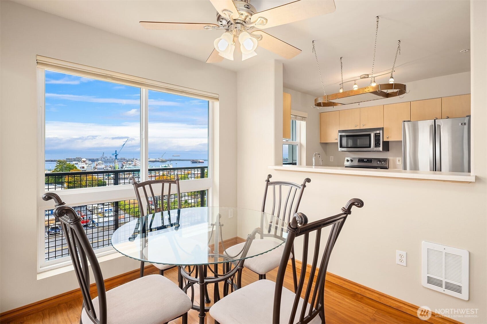 Dining area off of kitchen with views through large windows.