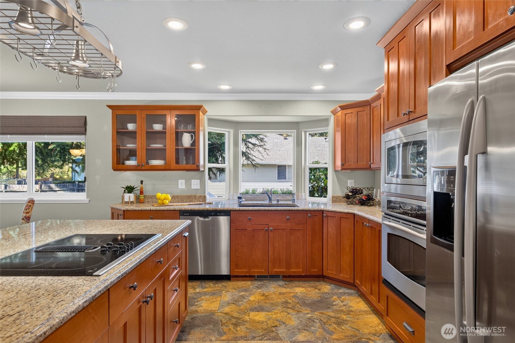 Kitchen with island and some luxury storage inside the cabinets.