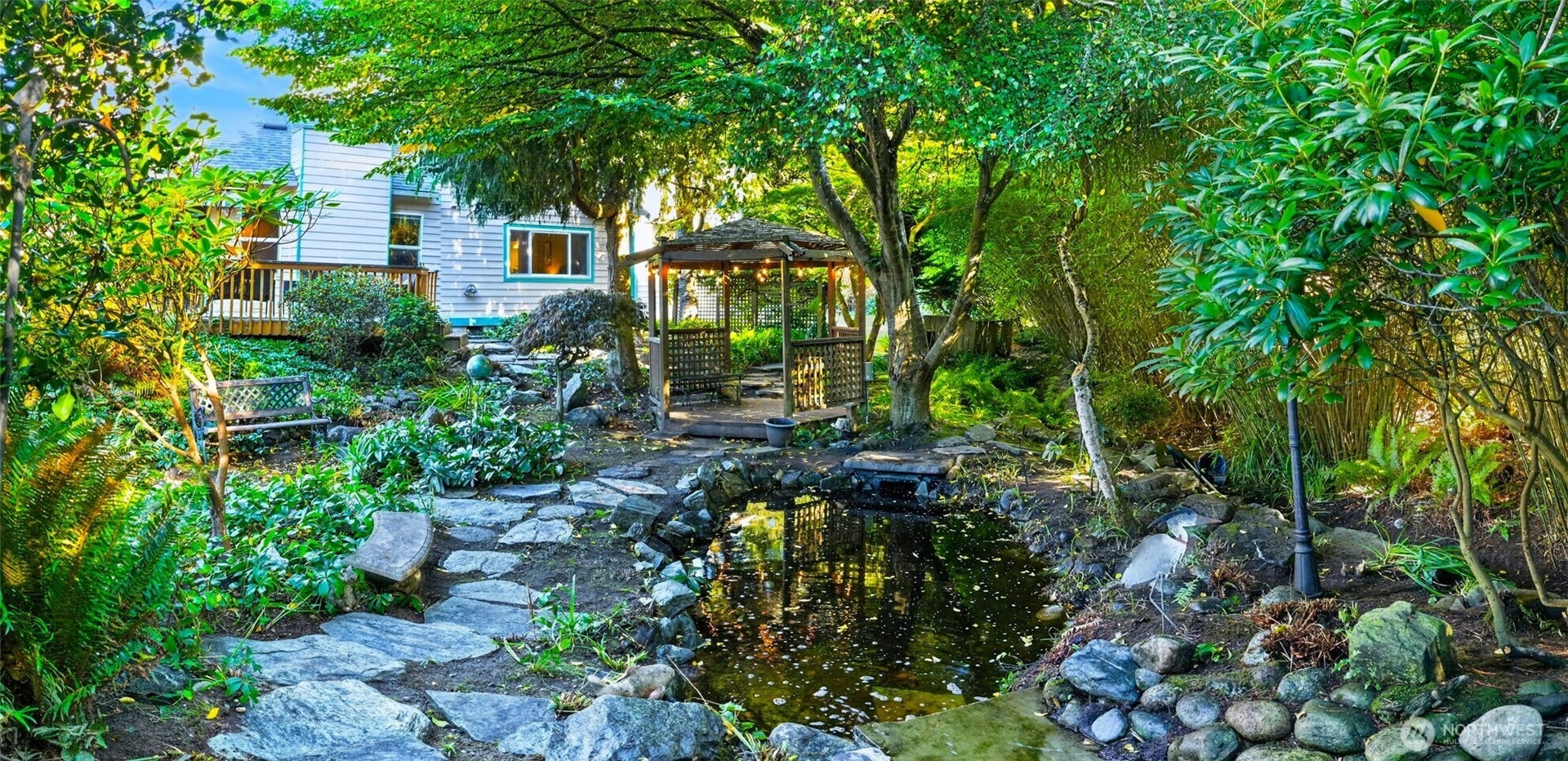 Backyard features an amazing water feature river and pond.