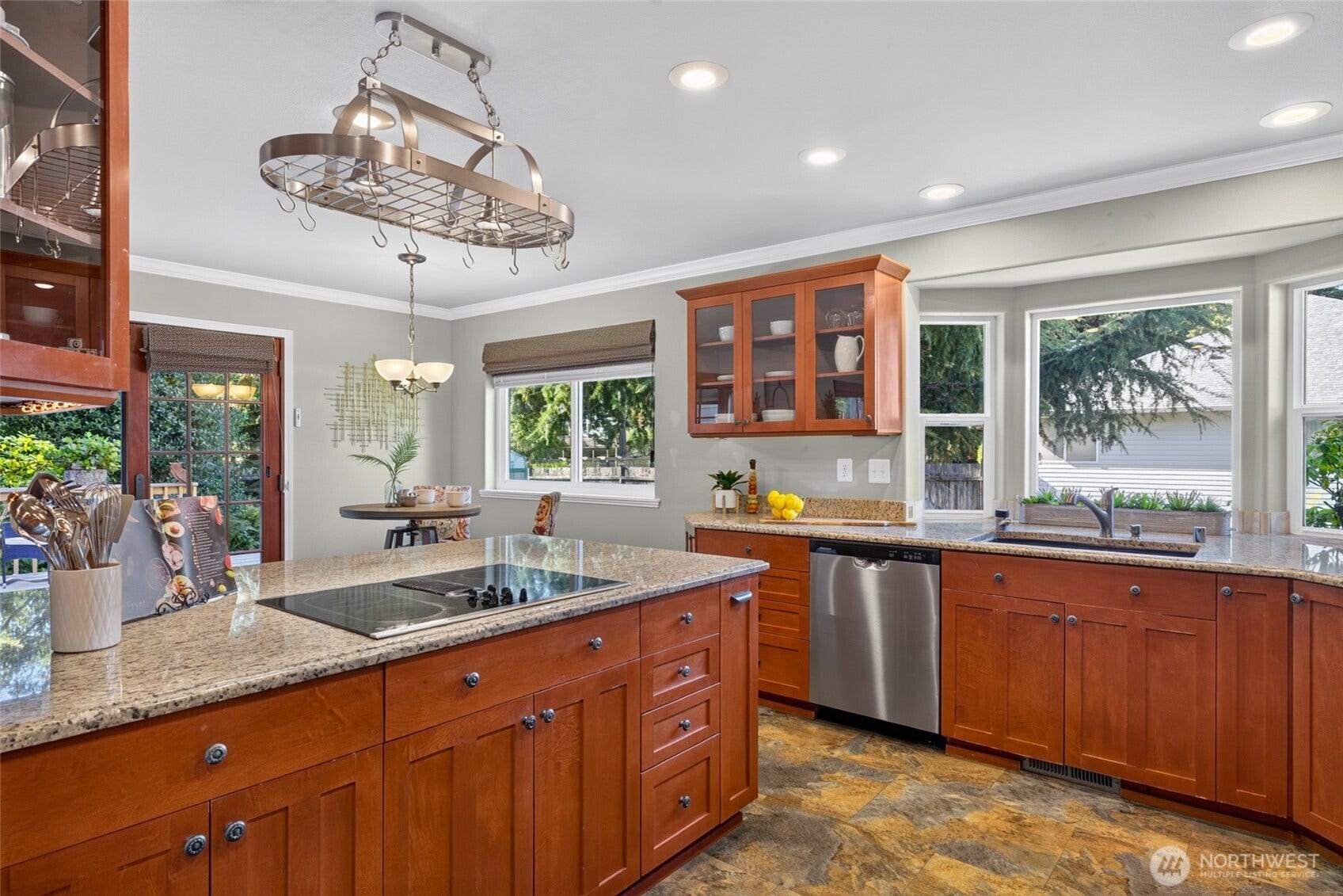 Granite countertops underneath the useful pot rack.