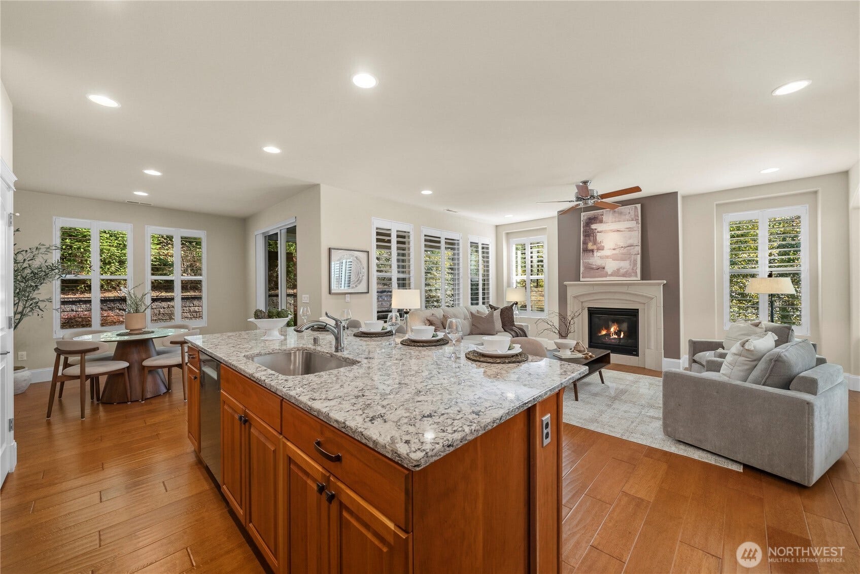 14721 Knoll Park Court E, Bonney Lake, WA 98391 The kitchen enjoys trees and nature vistas. Beautiful windows with Plantation shutters allow in a plethora of natural light and utmost privacy as the lot is elevated. The stunning concrete cast fireplace anchors the room.