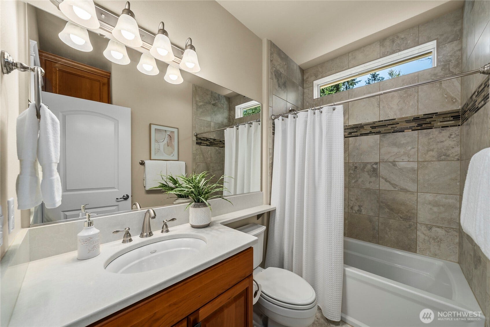 14721 Knoll Park Court E, Bonney Lake, WA 98391 Guest bath with Quartz counters, tile floors and shower surround.