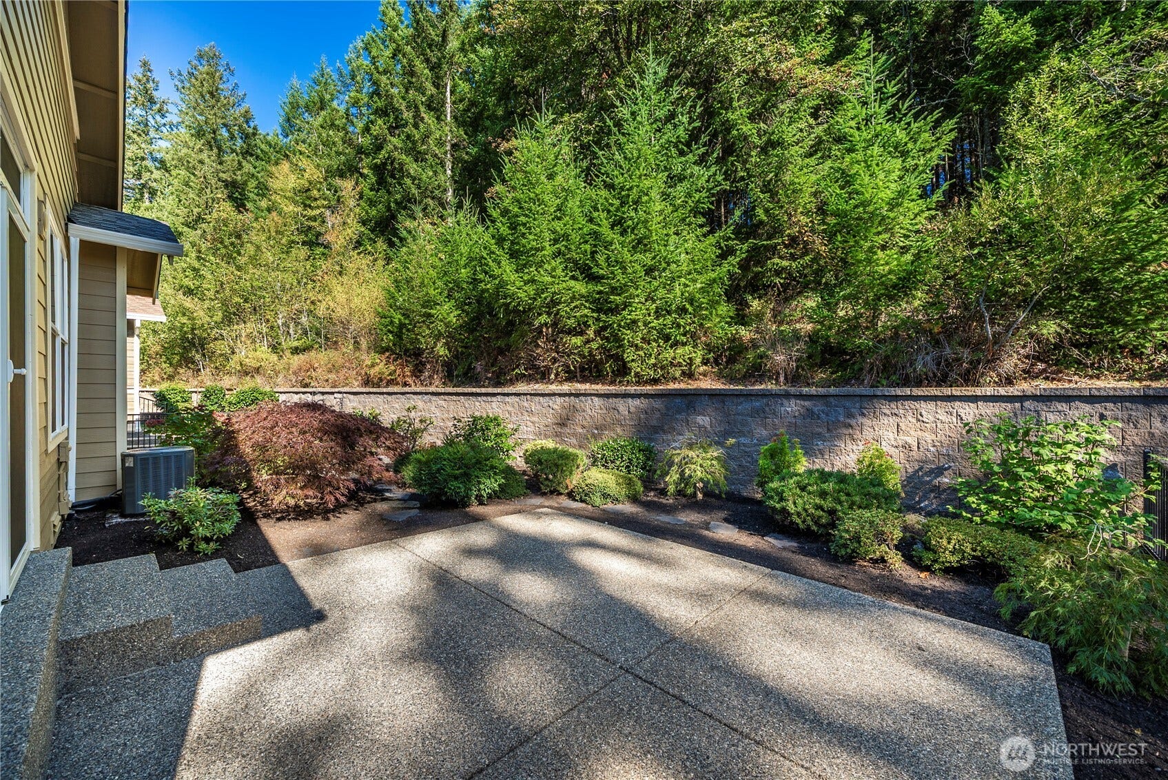 14721 Knoll Park Court E, Bonney Lake, WA 98391 Oversized patio nestled against the permanent greenbelt, a wonderful spot to gather or relax amongst the trees!