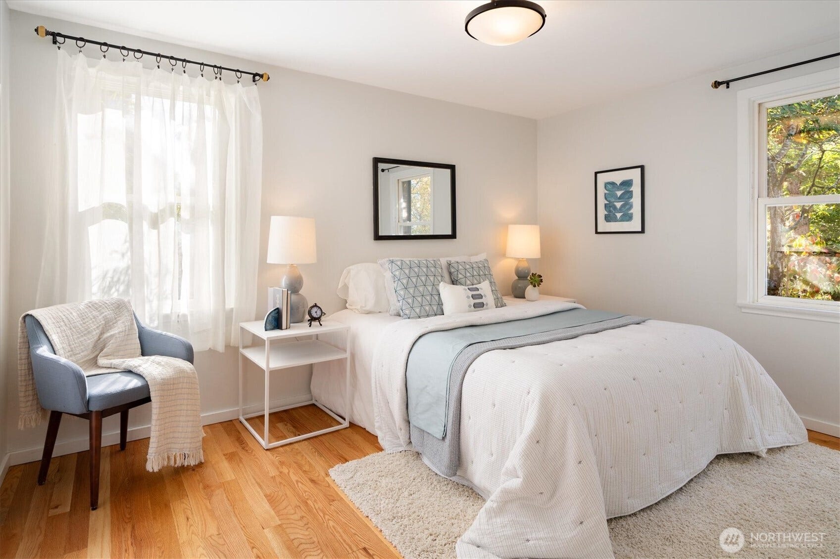 10523 13th Avenue NW, Seattle, WA 98177 The main floor primary bedroom has abundant light and gorgeous floors.