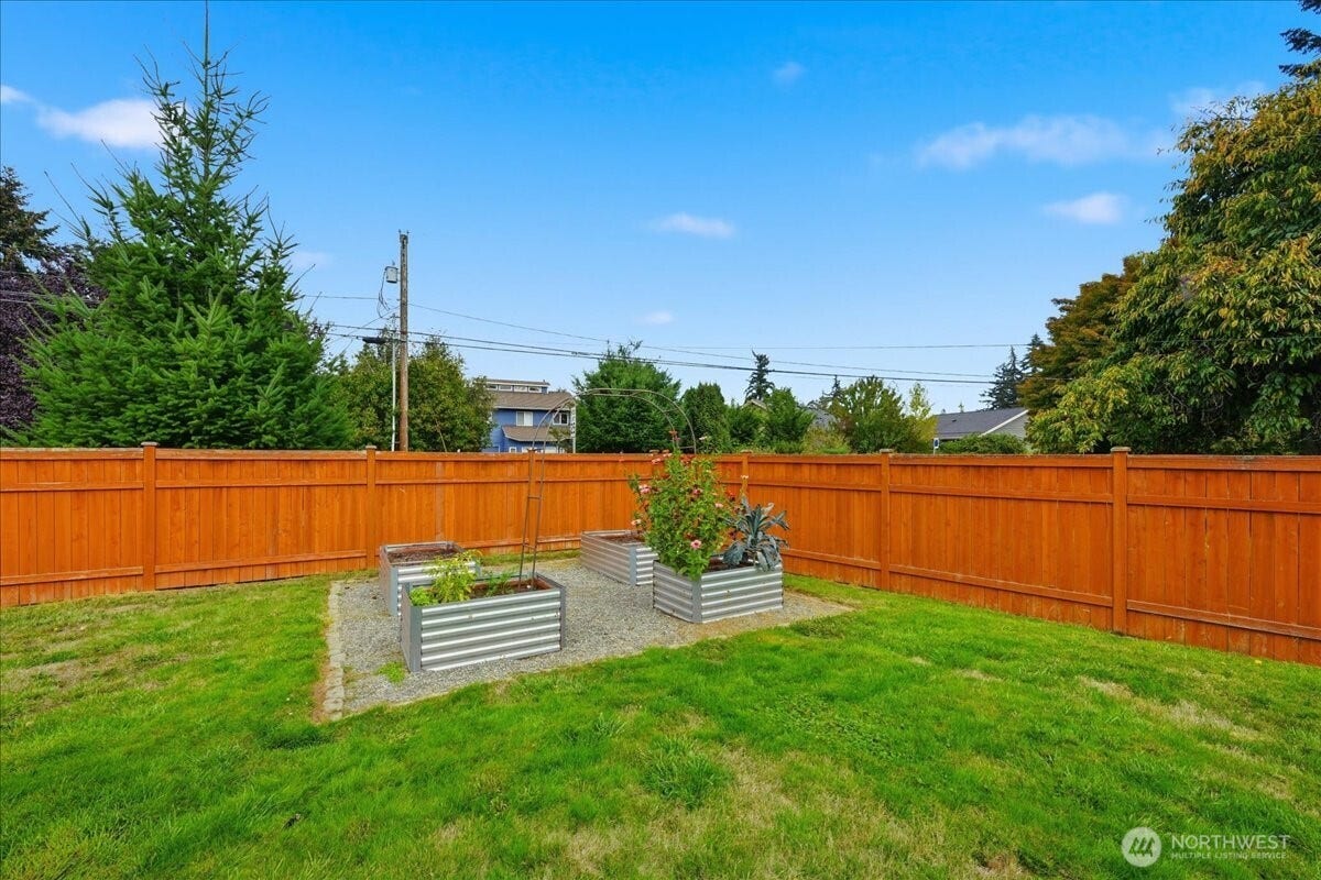 20807 3rd Avenue W, Lynnwood, WA 98036 Dedicated garden area with raised metal beds set on a gravel base. Perfect for vegetables, herbs, flowers and easy backyard gardening