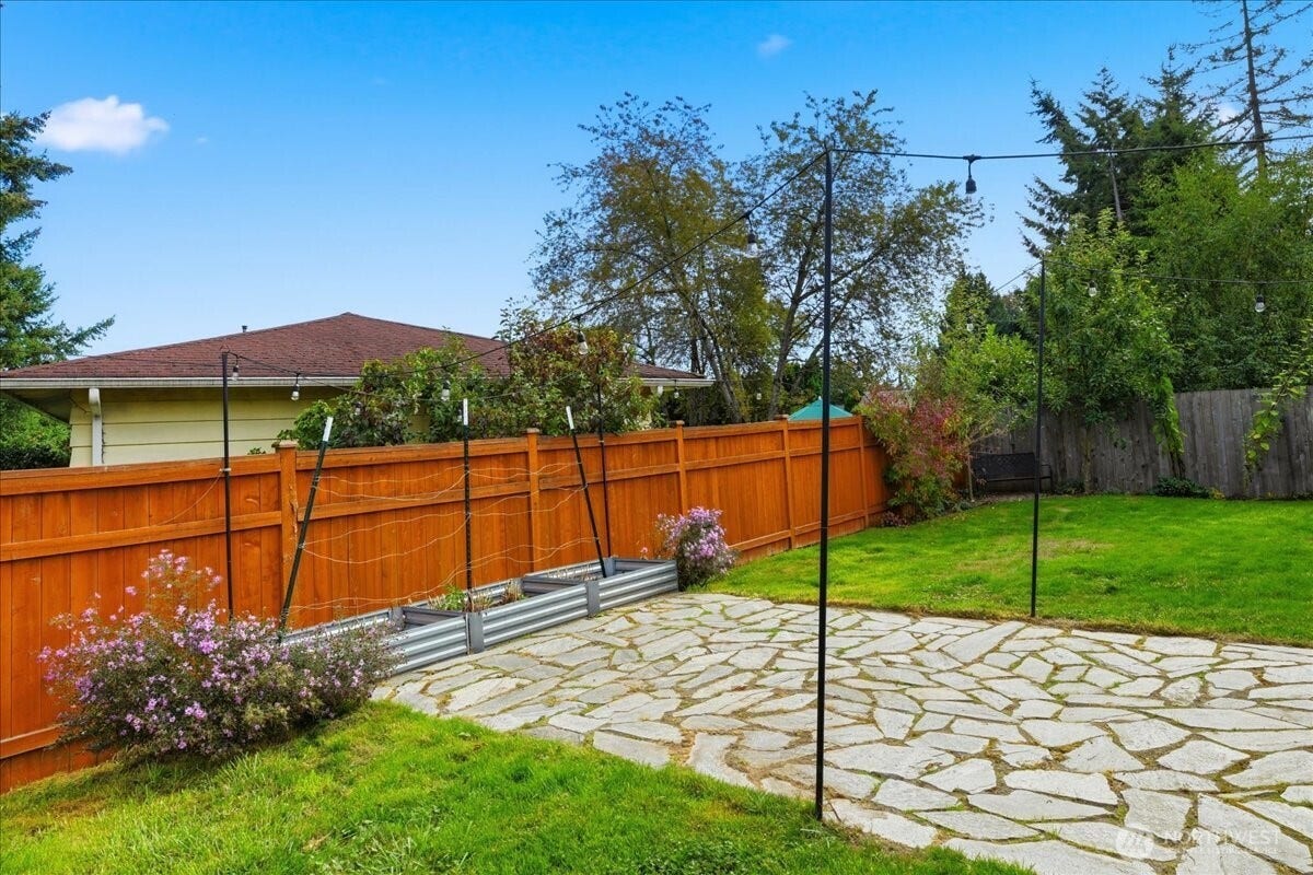20807 3rd Avenue W, Lynnwood, WA 98036 Charming flagstone patio and overhead bistro lights make for an inviting setting