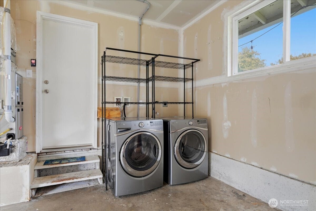 20807 3rd Avenue W, Lynnwood, WA 98036 Convenient laundry area within the garage offers room for additional shelving and storage, keeping everyday essentials organized. Washer and dryer stay with the home!