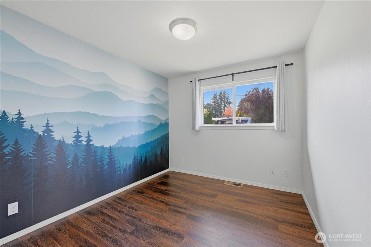 20807 3rd Avenue W, Lynnwood, WA 98036 Versatile secondary bedroom featuring a striking mountain mural accent wall that adds a classic Pacific Northwest feel