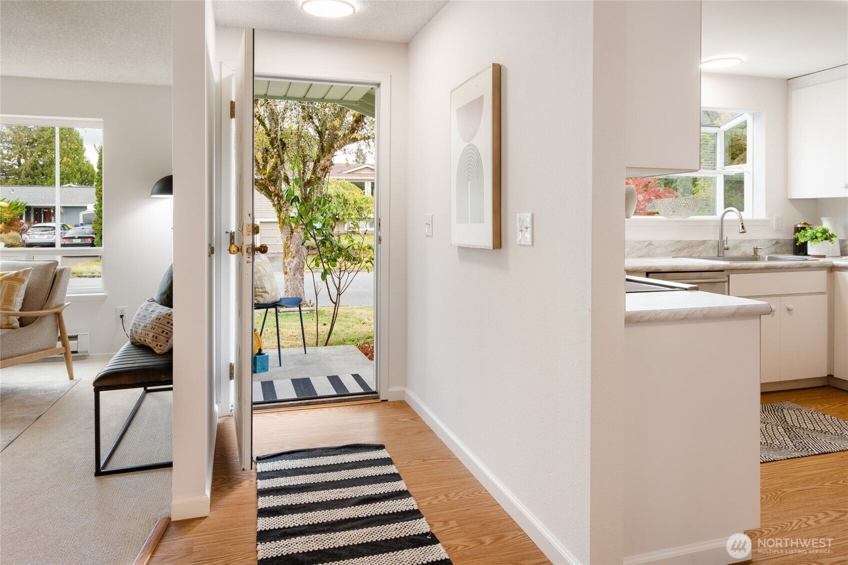 The entry leads to lovely living room and light filled kitchen.