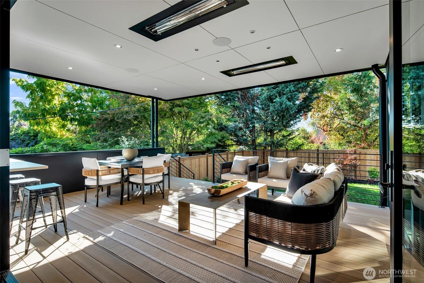 6021 Princeton Avenue NE, Seattle, WA 98115 Heated deck with built-in speakers and gas for BBQ's. Accessed via bi-fold doors for indoor-outdoor living.