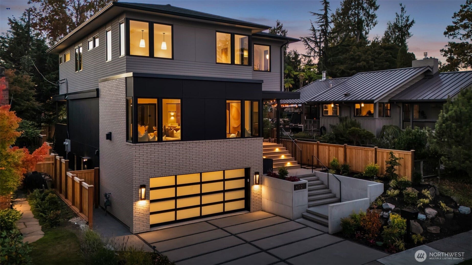 6021 Princeton Avenue NE, Seattle, WA 98115 Tasteful top-cast driveway, elevated brick and Hardie Board siding, & accent stair and landscape lighting provide a refined exterior aesthetic.