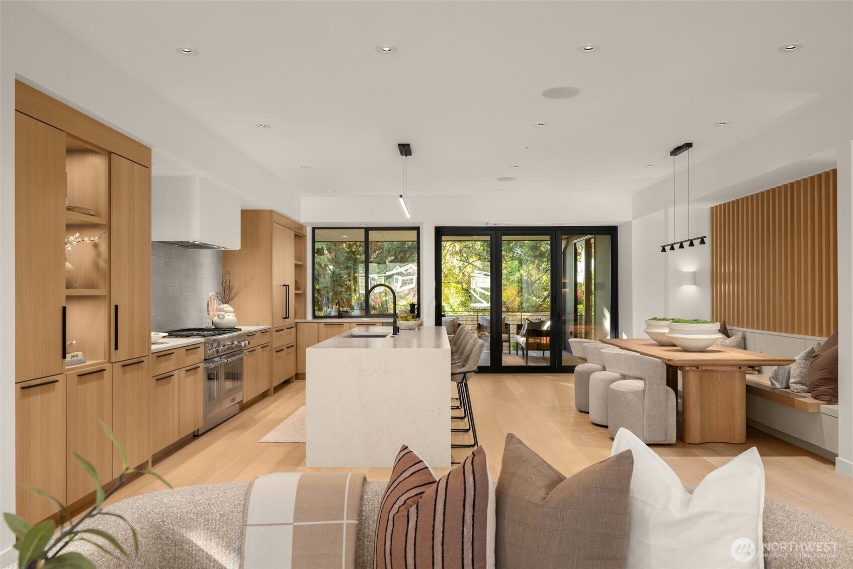 6021 Princeton Avenue NE, Seattle, WA 98115 Entertainer's kitchen with expansive gathering island, high-end Thermadoor appliances, honed quartz from Cambria, and custom dining seating.
