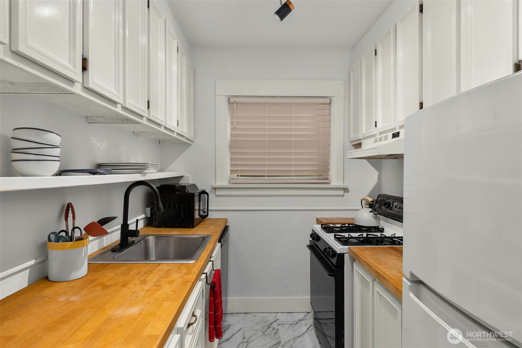 516 E Thomas Street, #102, Seattle, WA 98102 The kitchen featuring a gas range, butcher block countertops, dishwasher & plenty of cabinet space.
